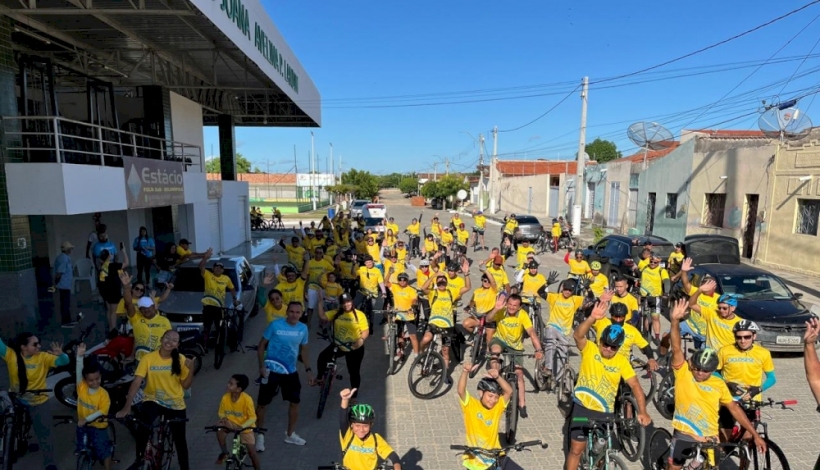 Participantes do CicloSesc 2024 em Solonópole pedalando pelas ruas da cidade, rumo à Capela Nossa Senhora de Fátima.